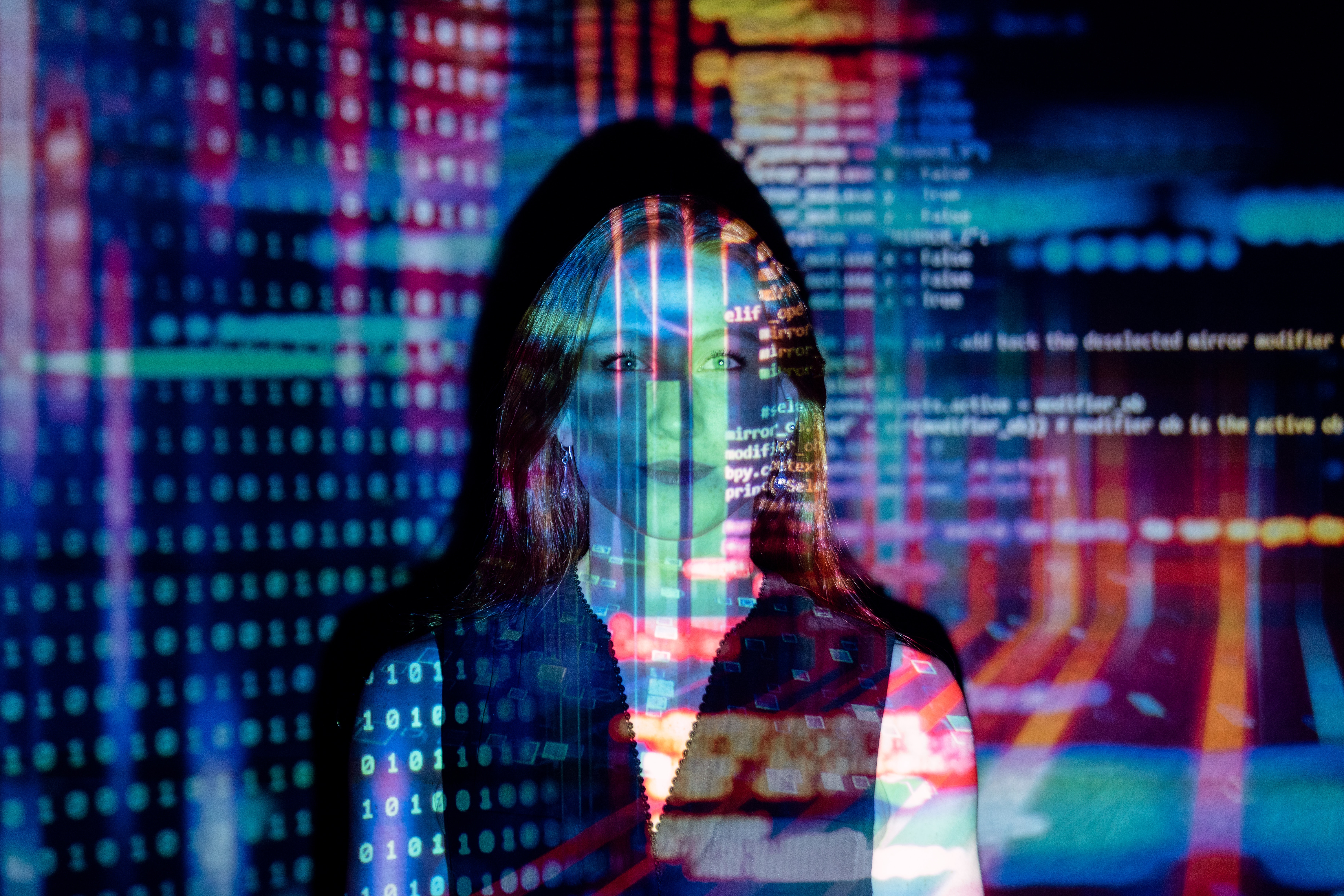 Image of a woman bathed in technology graphics