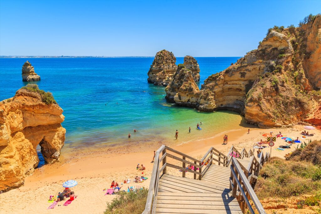 A beach in Lagos, Portugal. Living abroad is a chance to live a better life, on sale.